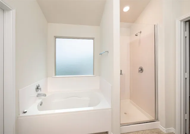 a white bath tub sitting next to a shower