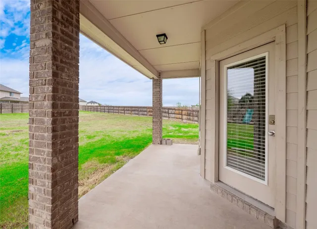 a view of a room and porch with a floor to ceiling window