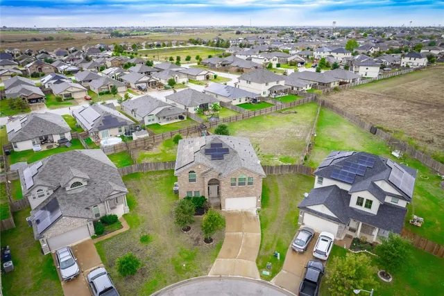 an aerial view of a house with outdoor space