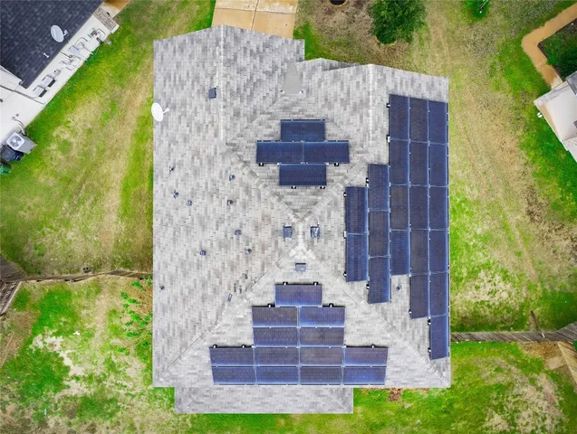 a aerial view of a house with a yard