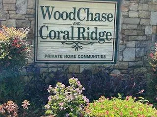 a sign broad in front of flowers