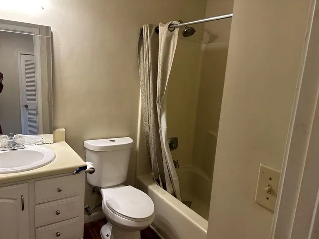 a white toilet sitting next to a bathroom sink