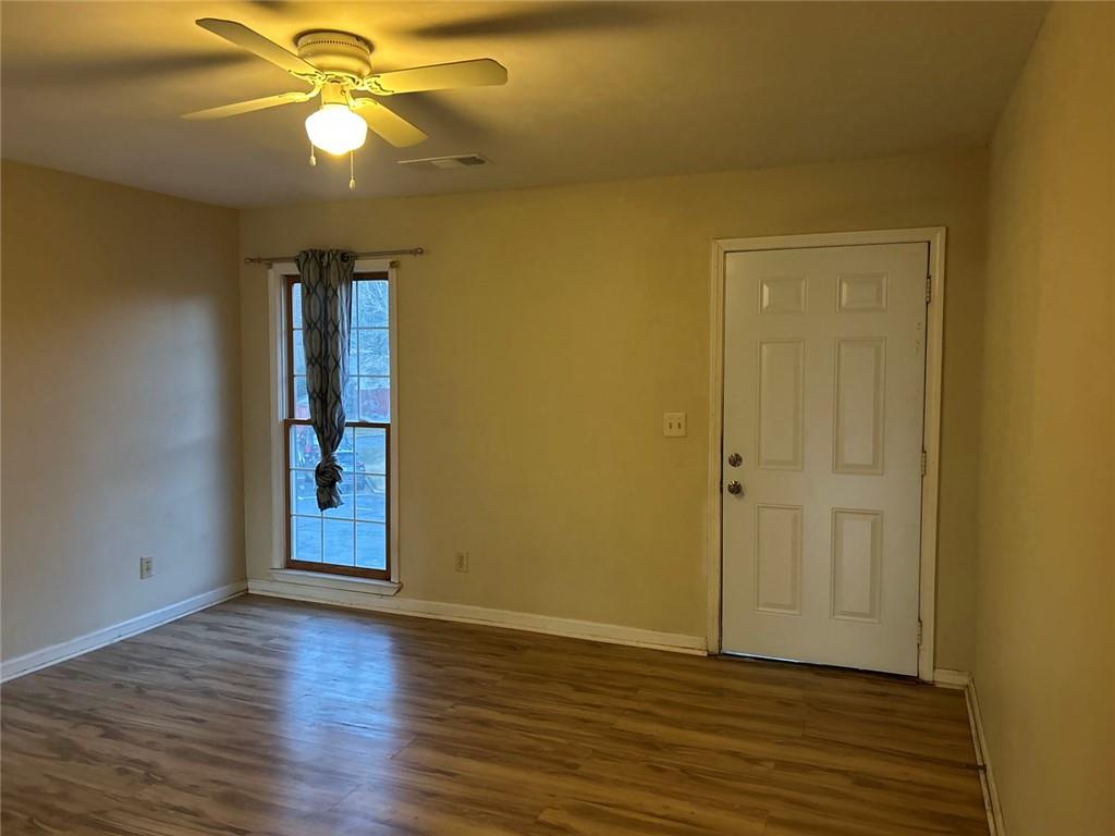 1166 Booth Road Southwest, Unit 709 Marietta, GA 30008 - Photo 12 of 12 a view of an empty room with wooden floor