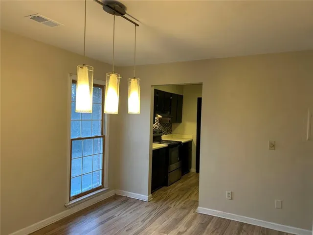 a view of a kitchen from a hallway