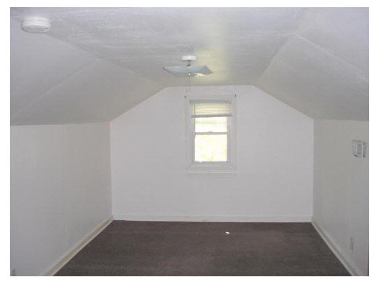 414 Fitch Road Rockford, IL 61109 - Photo 7 of 10 an empty room with wooden floor and windows