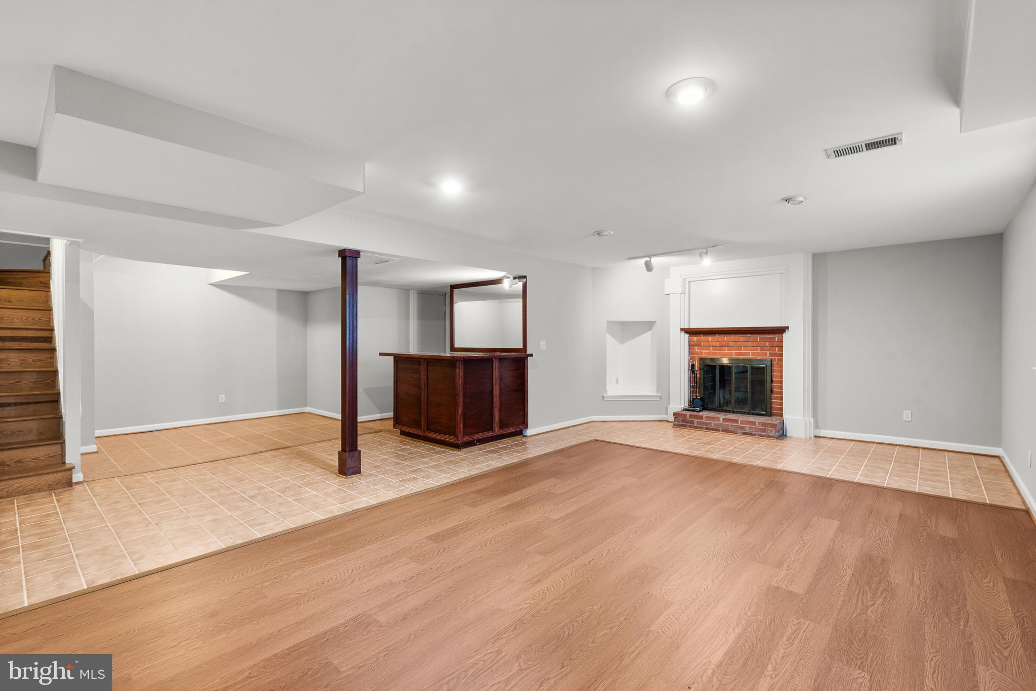 10711 Sandy Landing Road Potomac, MD 20854 - Photo 23 of 36 Finished Basement with bar & fireplace
