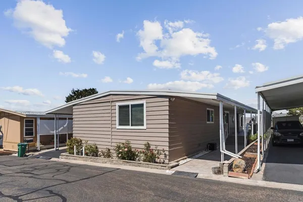 a backyard of a house with table and chairs