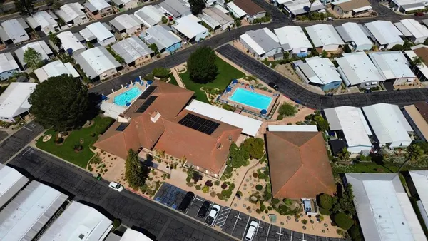 an aerial view of a house with a yard