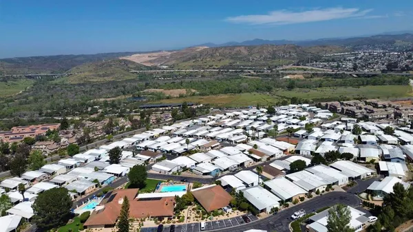 an aerial view of residential houses with outdoor space and river