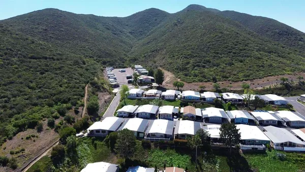 an aerial view of a house with mountain view