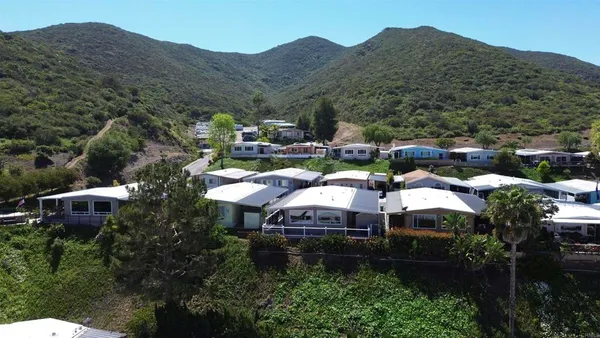 a view of a house with yard and outdoor seating