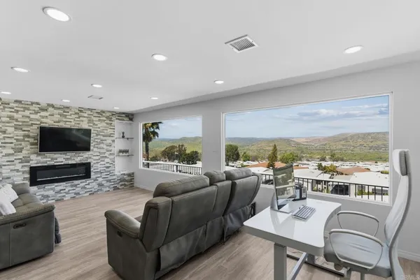 a living room with furniture flat screen tv and a fireplace