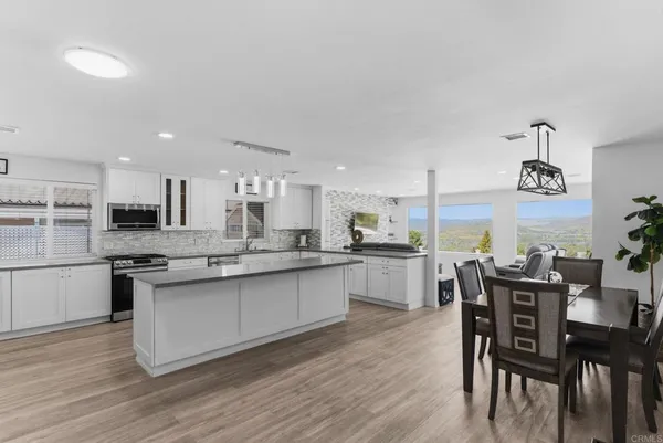 a large kitchen with a table and chairs in it