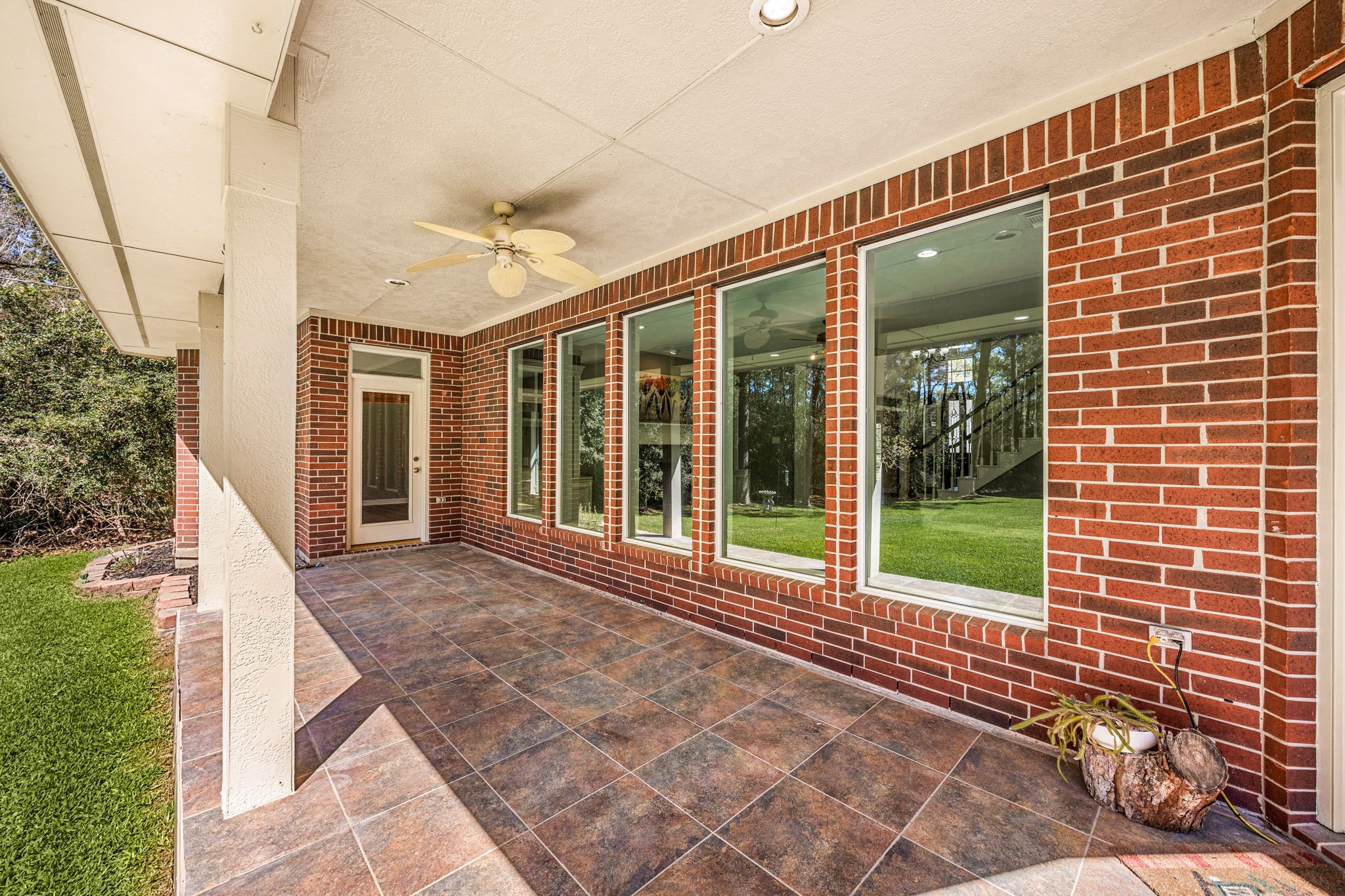 14419 Timbergreen Drive Magnolia, TX 77355 - Photo 29 of 43 Enjoy outdoor living under the covered patio featuring ceiling fan, brick exterior, and plenty of space for seating and gatherings.