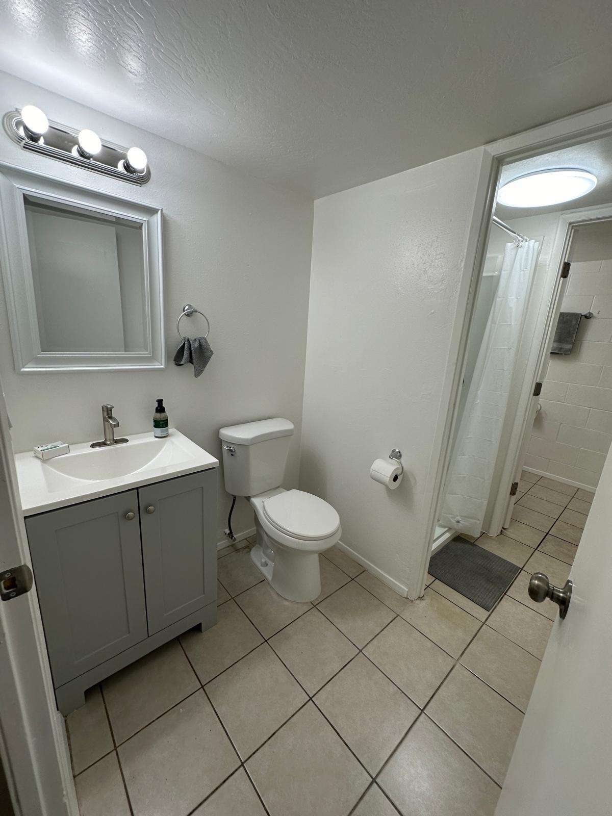 111 Kahului Beach Road, Unit C116 Kahului, HI 96732 - Photo 11 of 14 a bathroom with a toilet sink and mirror