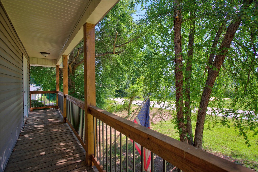 712 Beech Drive Seneca, SC 29678 - Photo 28 of 41 A welcoming front porch offers a peaceful vantage point overlooking vibrant greenery.