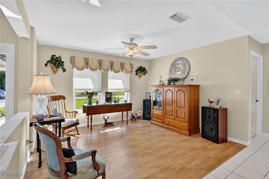 4306 Southwest 3rd Avenue Cape Coral, FL 33914 - Photo 5 of 50 a living room with furniture a chandelier fan and a window