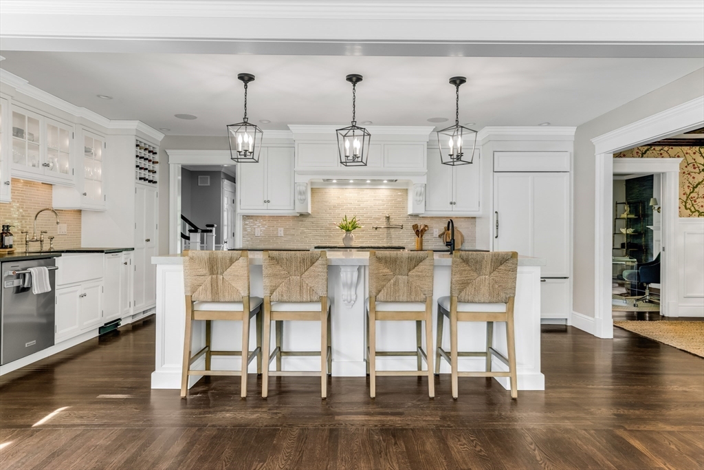 85 Old Farm Road Milton, MA 02186 - Photo 3 of 42 a dining room with wooden floor white glass table and chairs