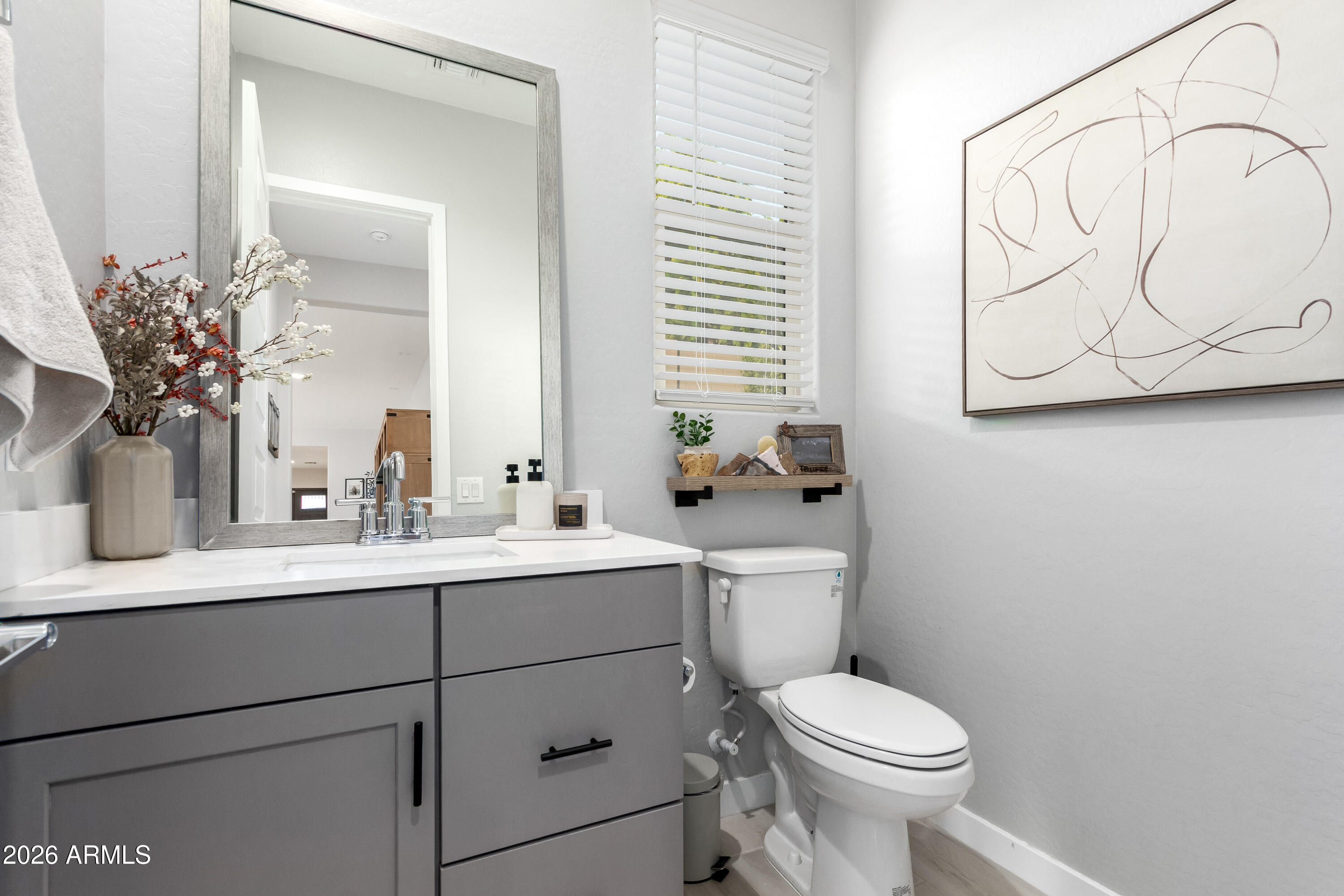2034 West Sleepy Ranch Road Phoenix, AZ 85085 - Photo 19 of 35 a bathroom with a toilet sink and mirror