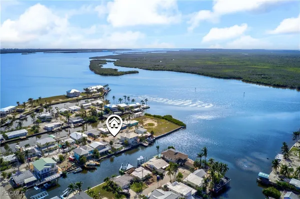 an aerial view of a house with a garden and lake view