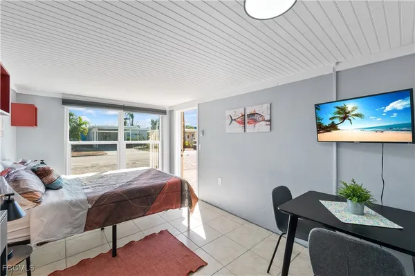 a bedroom with a bed and a chandelier