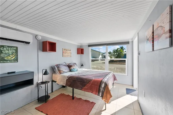 a white toilet sitting next to a bathroom sink and a potted plant
