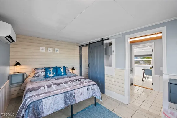 a bedroom with a bed a table and chair