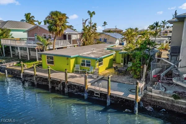 an aerial view of a house with a yard and furniture