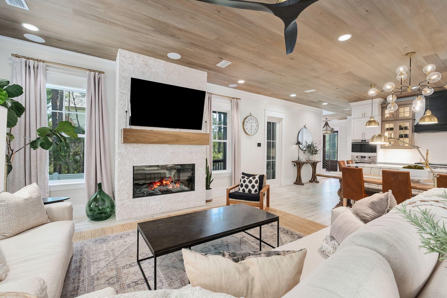 9 Bowline Alley Santa Rosa Beach, FL 32459 - Photo 16 of 52 a living room with furniture a flat screen tv and a fireplace