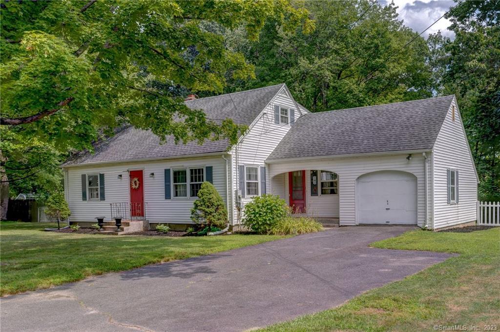 a front view of house with yard and green space