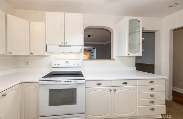 a kitchen with cabinets appliances and a counter space