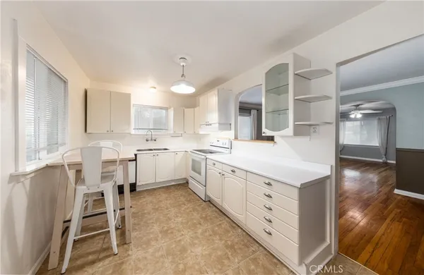 a kitchen with white cabinets and white appliances