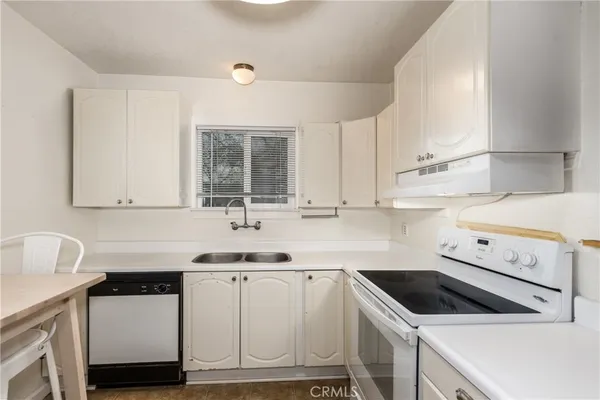 a kitchen with white cabinets sink and white appliances