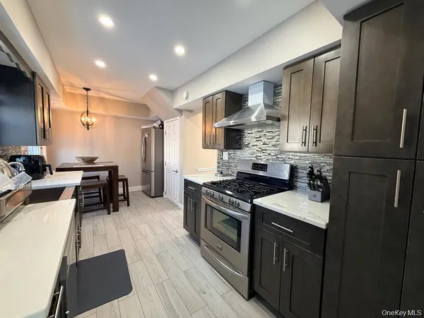 a kitchen with a sink stove and refrigerator