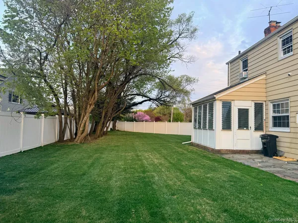 a view of house with backyard