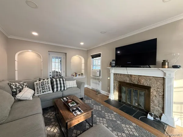 a living room with furniture a fireplace and a flat screen tv