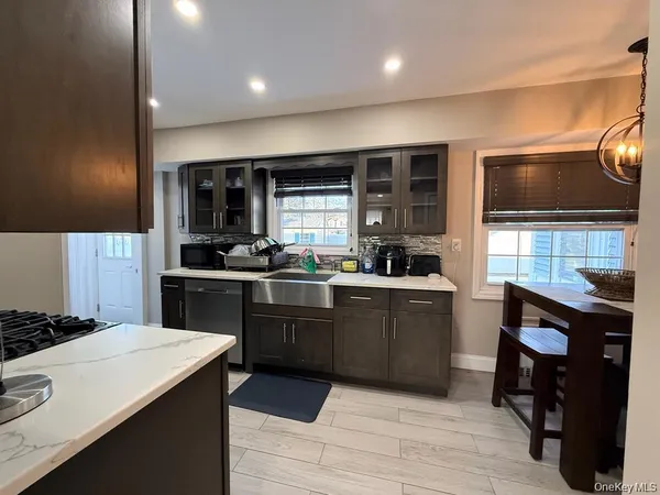 a kitchen with a sink cabinets and window