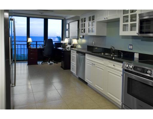 1800 South Ocean Boulevard, Unit 3C Boca Raton, FL 33432 - Photo 6 of 21 a kitchen with a sink stove and cabinets