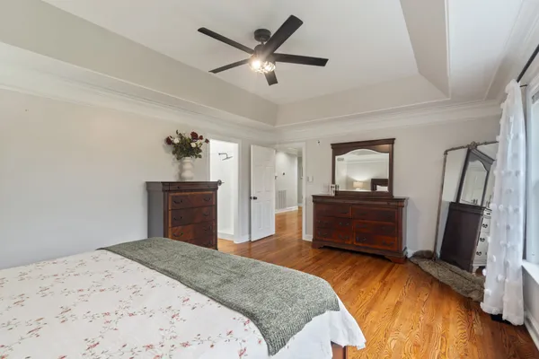 a bedroom with a bed and a dresser in it