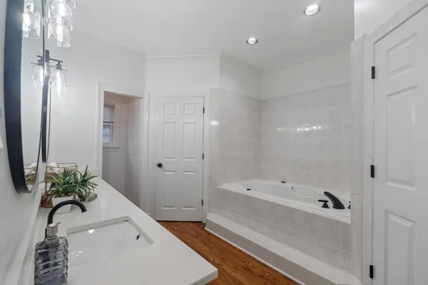 a bathroom with a bathtub and a sink
