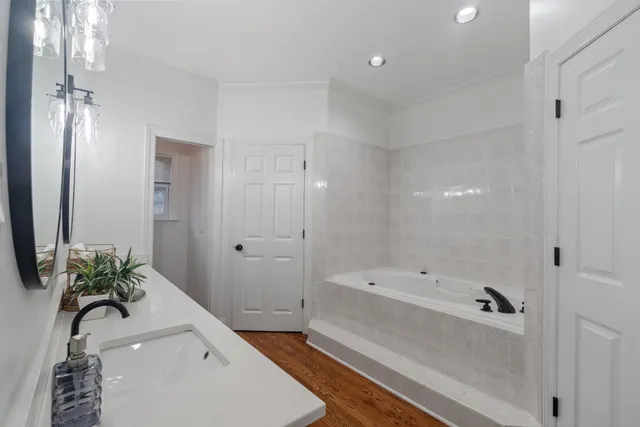 a bathroom with a bathtub and a sink