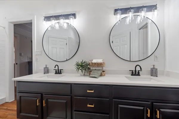 a bathroom with a double vanity sink and a mirror