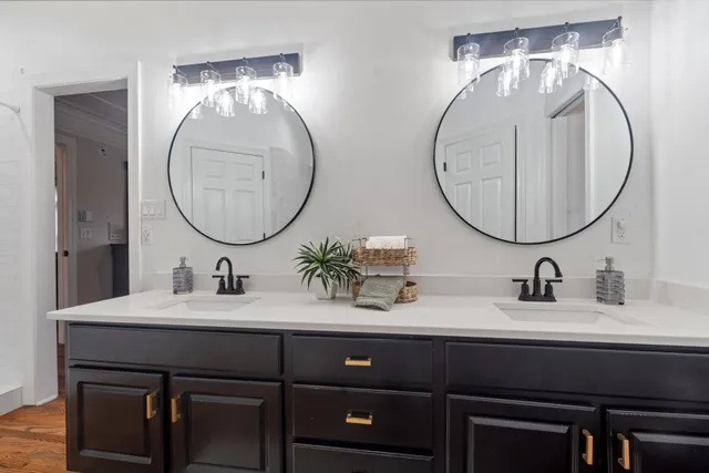 a bathroom with a double vanity sink and a mirror