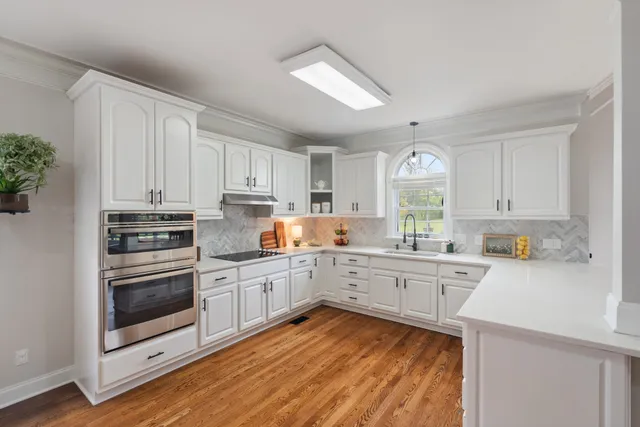a kitchen with stainless steel appliances a refrigerator and a stove top oven