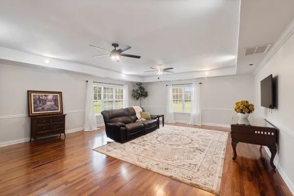 a living room with furniture and wooden floor