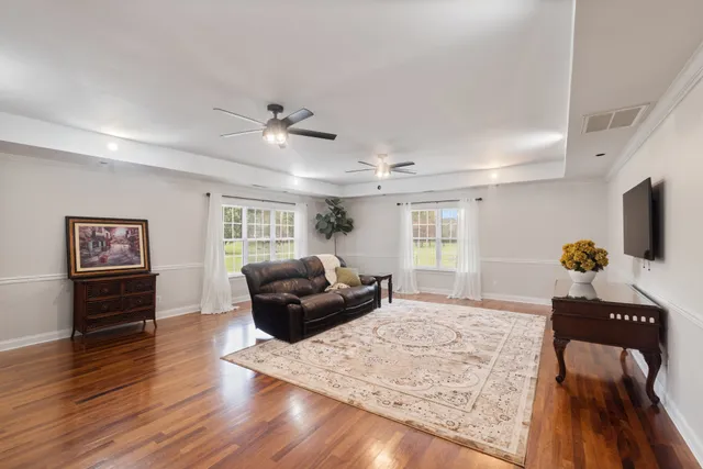 a living room with furniture and wooden floor