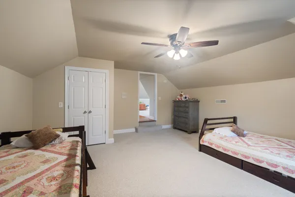 a bedroom with furniture and a large window