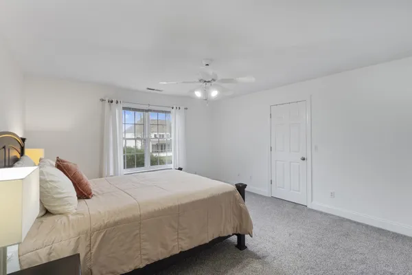 a view of a livingroom with wooden floor and stairs