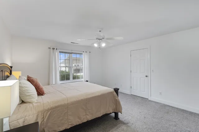 a view of a livingroom with wooden floor and stairs