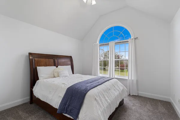 a bathroom with a granite countertop sink toilet a mirror and shower